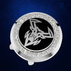 A round silver-toned car horn button cover featuring a black center with a stylized white ram's head emblem, surrounded by a border of clear rhinestones, set against a dark blue textured background.