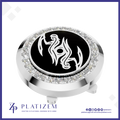 A round silver-toned golf ball marker cap featuring a black center with a white stylized bird emblem, surrounded by a halo of clear crystals. The brand name 'PLATIZEM' is visible at the bottom of the image.