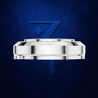 A polished silver-toned circular watch case or bracelet component centered on a deep blue textured background, with a large blue stylized number 7 behind it.
