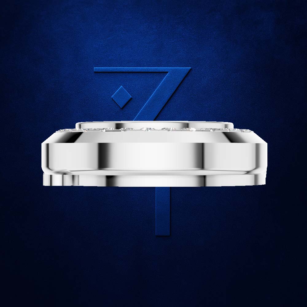 A polished silver-toned circular watch case or bracelet component centered on a deep blue textured background, with a large blue stylized number 7 behind it.