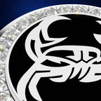 A close-up of a circular black and white emblem or medallion with a stylized white graphic on a black field, surrounded by a border of clear faceted gemstones on a dark blue background.