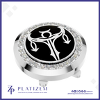 A round silver-toned golf ball marker with a black center featuring a white stylized golf hole symbol, surrounded by a halo of clear crystals. The brand name 'PLATIZEM' is visible at the bottom of the image.