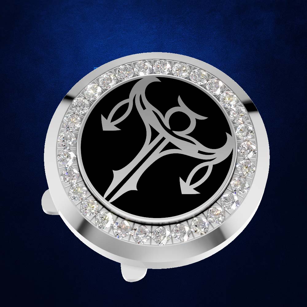 A round silver-toned car keychain fob featuring a black center with a silver triple-circle symbol, surrounded by a border of clear rhinestones, set against a dark blue textured background.
