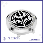 A round golf flag hole marker with a polished silver-tone metal body, a black center featuring a white stylized bird emblem, a halo of clear rhinestones, and a small flagstick extending downward. The brand name PLATIZEM is visible at the bottom of the image.