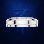 A polished silver-toned circular product, likely a watch crown or decorative hardware piece, centered against a textured dark blue background with a large blue stylized '7' behind it.