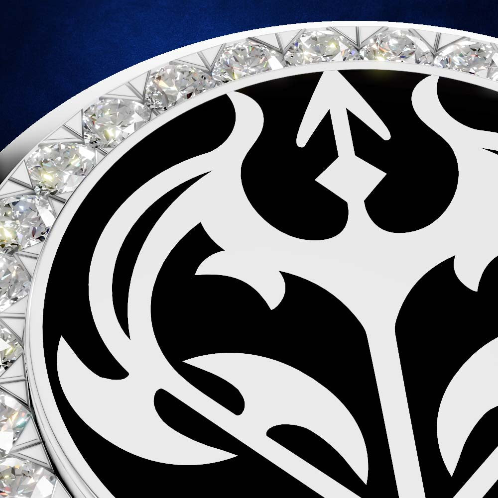 Close-up of a circular jewelry piece featuring a bold black and white ornamental pattern, surrounded by a border of clear faceted gemstones on a white metal setting, against a deep blue background.