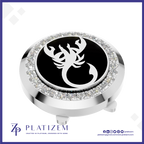 A round golf club headcover featuring a polished silver-tone metal bezel set with clear crystals, a central black circular insert with a white scorpion emblem, and a matching silver base. The brand name 'PLATIZEM' is visible at the bottom of the image.