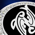 A close-up of a circular black and white emblem or medallion with an ornate white abstract symbol on a black field, bordered by a ring of clear faceted stones against a dark blue background.