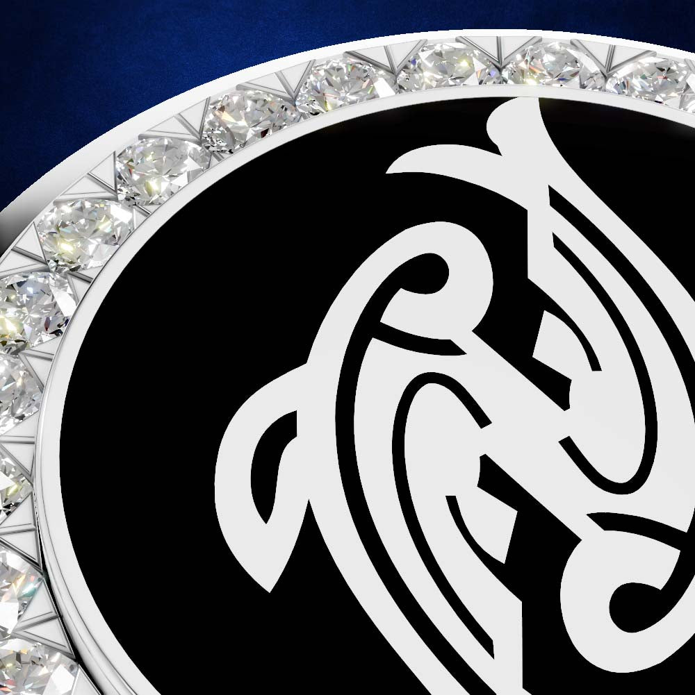 A close-up of a circular black and white emblem or medallion with an ornate white abstract symbol on a black field, bordered by a ring of clear faceted stones against a dark blue background.