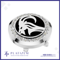 A round silver-tone golf club headcover with a black center featuring a white ram head logo, surrounded by a halo of clear rhinestones. The Platizem brand logo is visible at the bottom of the image.