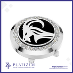 A round silver-tone golf club headcover with a black center featuring a white ram head logo, surrounded by a halo of clear rhinestones. The Platizem brand logo is visible at the bottom of the image.