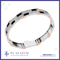 A silver and rose gold geometric bracelet with black inlay panels and rows of clear stones, shown on a white background with the Platizem brand logo at the bottom.