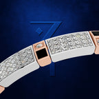 A close-up of a luxury bracelet featuring pavé diamonds, rose gold accents, and a black square inlay, set against a dark blue textured background with a stylized blue number 7.