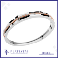 A geometric silver-toned ring with a rose gold accent stripe and pavé-set clear stones, shown on a white background with the Platizem brand logo at the bottom.