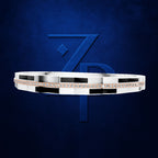 A modern geometric silver ring with a row of small clear stones and rose gold accents, displayed against a dark blue textured background with a stylized blue 'ZP' logo.