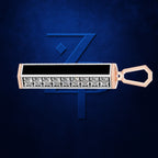 A rectangular pendant or keychain-style jewelry piece with a row of clear gemstones on a rose gold-toned base, shown against a dark blue textured background with a stylized blue 'Z' logo behind it.