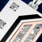 Close-up of a geometric silver-toned pendant or brooch with clear faceted gemstones, a black chevron accent, and a rose-gold inner frame, shown against a dark blue background.