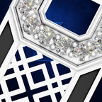 Close-up of a geometric jewelry piece with a white frame, deep blue inlay sections, and a row of clear faceted gemstones along the top edge.