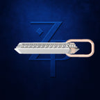 A silver-toned barrette-style hair clip embellished with a row of clear stones, featuring a rose gold loop end, set against a dark textured blue background with a stylized blue 'ZP' logo.