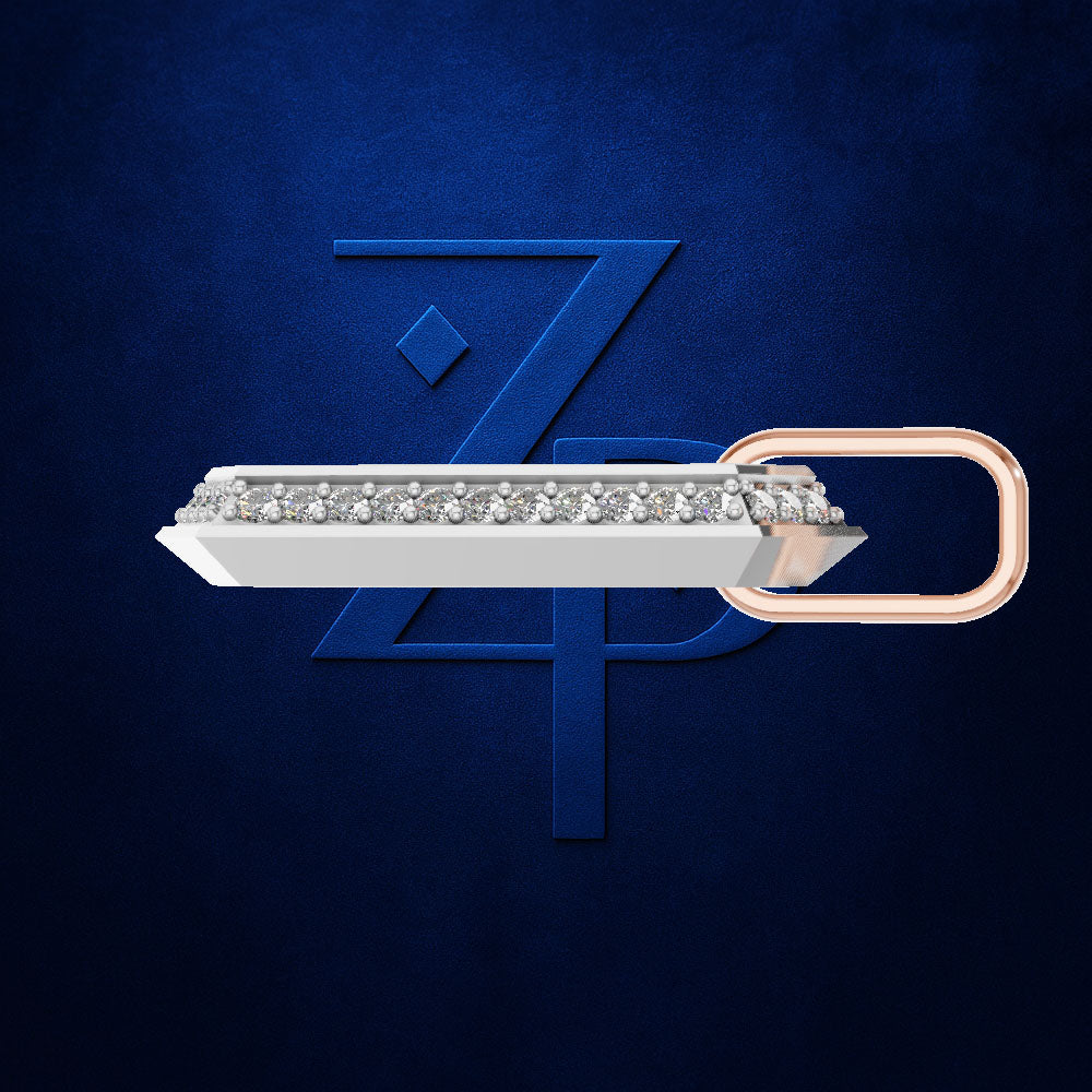 A silver-toned barrette-style hair clip embellished with a row of clear stones, featuring a rose gold loop end, set against a dark textured blue background with a stylized blue 'ZP' logo.
