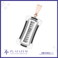 A 3D digital rendering of a rectangular pendant with a rose gold bail, featuring a central channel of round-cut clear gemstones in a silver-toned setting, surrounded by white and black geometric accents. The brand logo 'PLATIZEM' is visible at the bottom left.