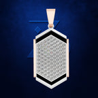 A geometric pendant necklace featuring a pavé diamond center, accented with black and white inlays and rose gold side panels and bail, set against a textured dark blue background.