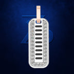 A rectangular dog tag pendant with a silver-toned border paved with clear stones, featuring a central white inlay with horizontal black bars and a rose gold loop at the top, set against a dark blue textured background.