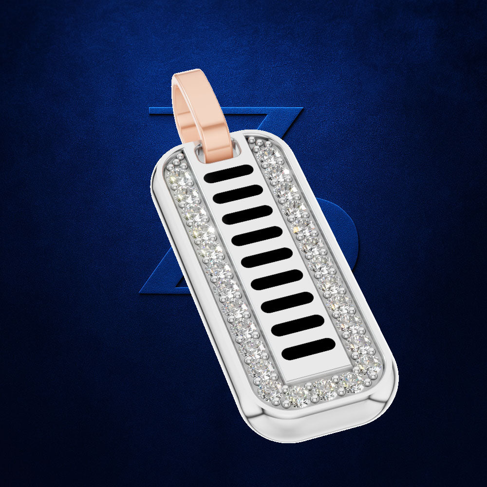 A silver-toned rectangular dog tag pendant with a rose gold loop, set with clear crystals around a central black-and-silver striped pattern, shown on a dark blue textured background.