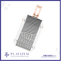 A rectangular platinum pendant with a wavy black and white enamel pattern and a pavé diamond-encrusted lower section, featuring rose gold-tone side accents and a top loop, shown on a white background with the Platizem brand logo.