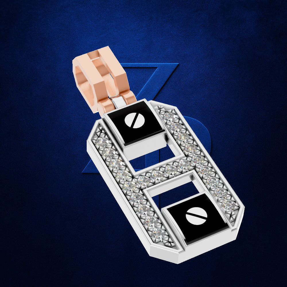 A silver-toned letter H pendant necklace embellished with clear crystals and featuring two black square inlays with white circular details, suspended from a rose gold bail, set against a dark blue textured background.
