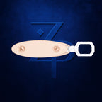 A close-up of a metallic keyring with a pale peach oval tag and a white hexagonal ring, shown against a dark blue textured background with a stylized blue 'ZPD' logo.