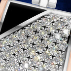 Close-up of a luxury watch dial featuring a large array of clear round-cut diamonds in a star-shaped bezel setting, with a rose gold-toned case edge and a dark blue inner crown guard.