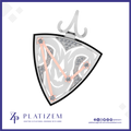 A shield-shaped pendant or brooch shown on a white background with branding at the bottom. The piece has a silver-toned outer frame and top clasp, a white center with gray abstract leaf-like lines, gray gemstone-set corner sections, and four rose-gold diagonal lines connecting the corners.