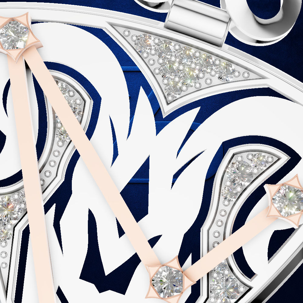 Close-up detail of a watch dial with a white and navy blue graphic design, silver-tone bezel and hands, and clear crystal accents.