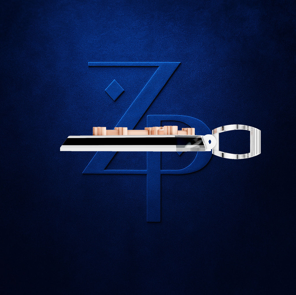 A silver metal belt clip with a polished rectangular buckle and a row of small rose gold-toned cylindrical studs, shown against a dark textured blue background with a large stylized blue 'ZPD' logo behind it.