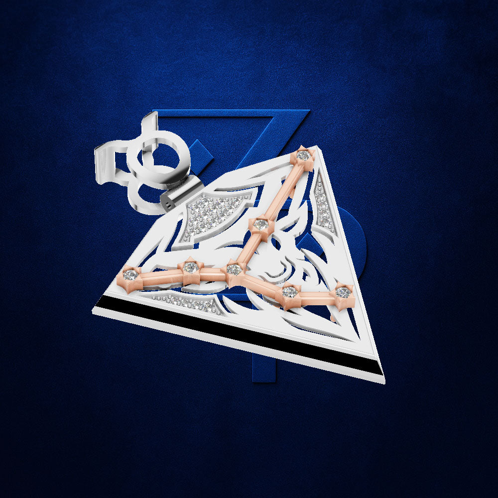 A geometric triangular pendant or brooch with a white and silver base, accented by rose gold lines and small clear stones, shown against a textured dark blue background.