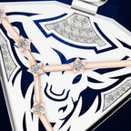 Close-up of a white and navy blue jewelry box lid featuring a stylized animal head design, decorated with rose gold bars and diamond accents.