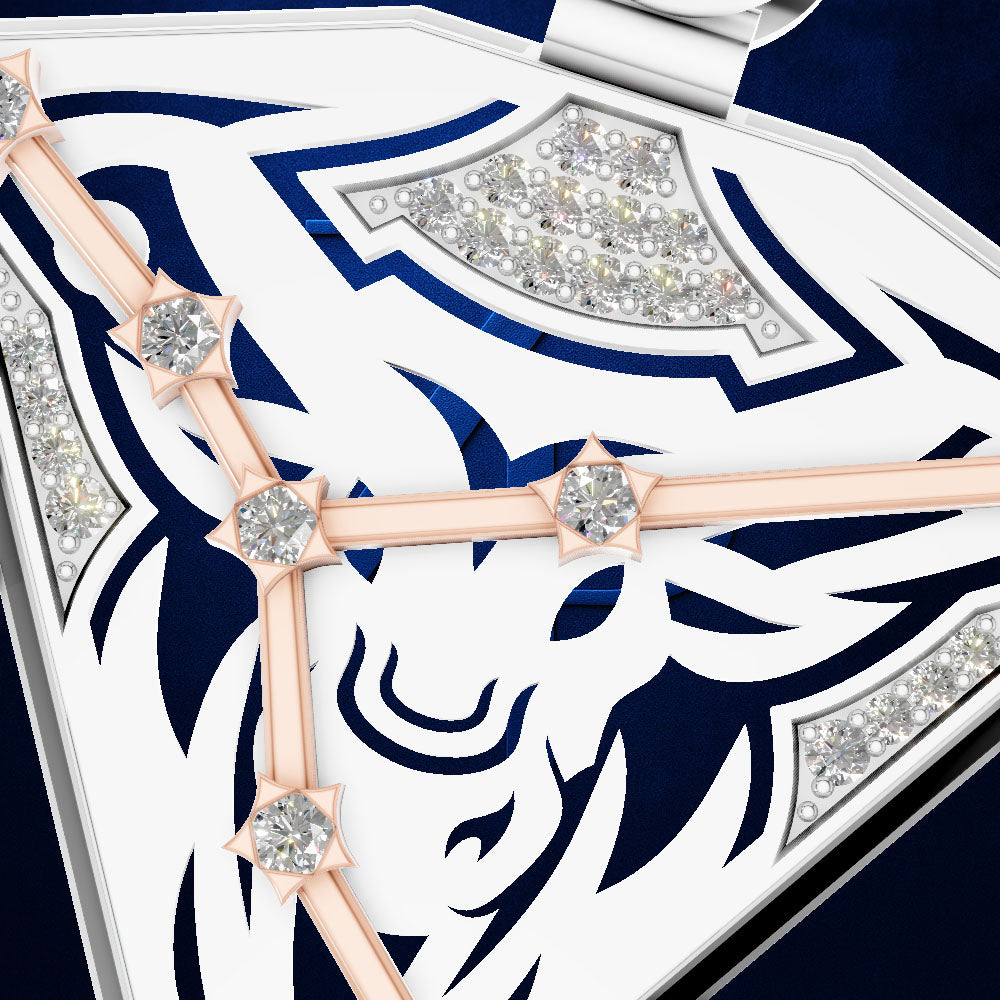Close-up of a white and navy blue jewelry box lid featuring a stylized animal head design, decorated with rose gold bars and diamond accents.