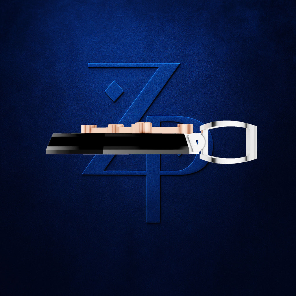A modern belt buckle with a black central bar, rose gold-toned studs, and a silver-toned metal loop, presented against a textured dark blue background with a stylized blue 'ZPD' logo.