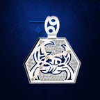 A silver-toned hexagonal pendant featuring a stylized crab design set with clear stones and pinkish-beige hands, suspended against a textured dark blue background.