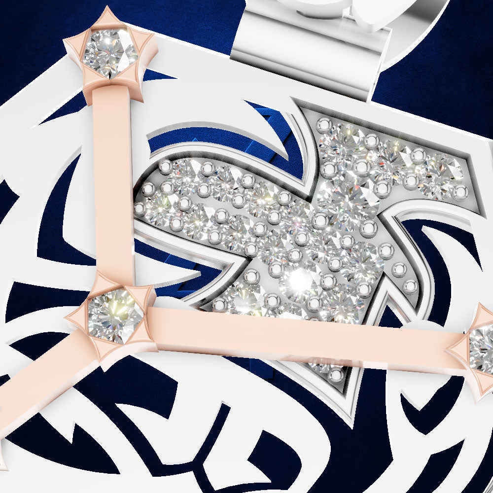 A close-up of a white and navy blue decorative item featuring a large silver-toned letter 'X' paved with clear rhinestones, accented by pale blush pink ribbon-like bars with crystal star-shaped connectors, set against a dark blue background.