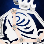 Close-up of a white and navy blue jewelry box lid featuring a stylized profile of a woman's face, a rose motif, and pale pink ribbon accents tied with clear crystal star-shaped bows, set against a dark blue background.