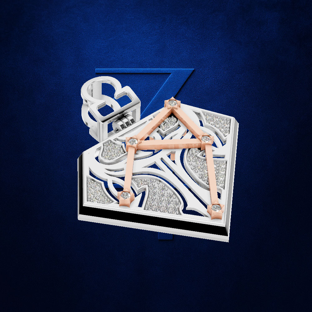 An ornate geometric jewelry piece featuring a rectangular silver-toned base with intricate white and blue sculpted patterns, connected by rose gold triangular bars, with a white ring element rising from the back, set against a dark blue textured background.
