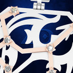 Close-up of a luxury watch dial featuring a white and navy blue geometric design with rose gold lines and clear crystal accents.