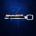 A stylized metallic key-shaped product with a silver body, black horizontal bar, and small peach-colored rectangular elements on top, centered over a large blue 'ZPD' monogram on a dark blue textured background.