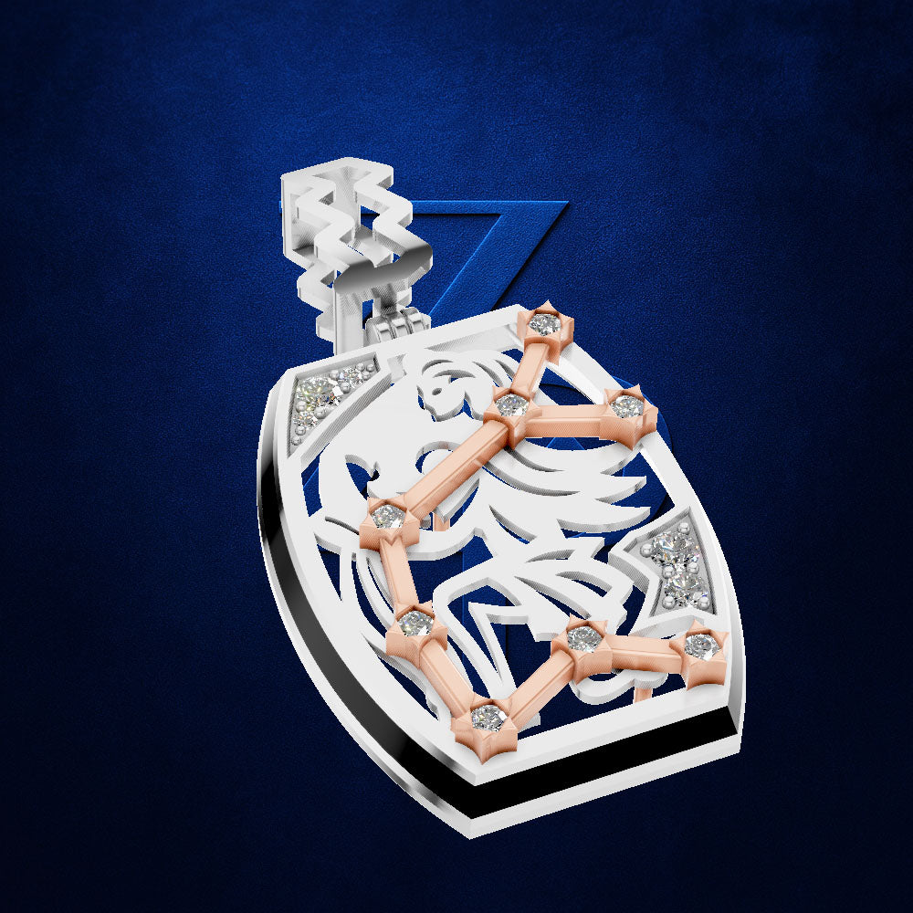 A shield-shaped pendant featuring a white eagle design with a rose gold constellation overlay and small clear gemstone accents, set against a textured dark blue background.