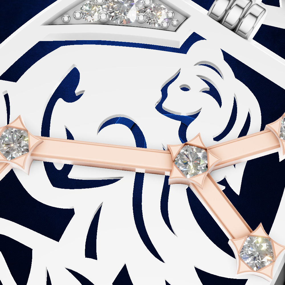 Close-up of a luxury watch dial featuring a white and navy blue geometric design with a stylized lion head motif, rose gold hour markers accented with clear crystals, and a silver crown.
