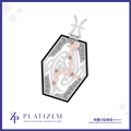 A hexagonal pendant necklace featuring a silver-toned Celtic knot design, a peach-pink constellational line drawing, and clear gemstone accents, shown on a white background with the brand name 'PLATIZEM' at the bottom.