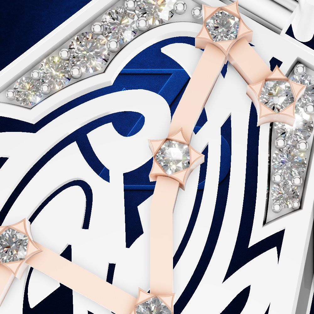 Close-up of a luxury watch dial featuring white and navy blue geometric Arabic numerals, rose gold hour markers with clear round gemstones, and diamond-studded silver bezel sections.