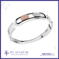 A silver-toned geometric bangle bracelet with two rectangular inset panels, one rose gold and one white gold or platinum, both embellished with small clear stones. The bracelet is displayed on a white background with a blue border, featuring the PLATIZEM brand logo at the bottom.